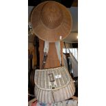 Old wickerwork fishing creel and a canework sun hat