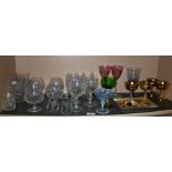 Assorted drinking glasses including 19th c. Bohemian vaseline wine glass and a quantity of sample