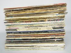 A collection of 12" vinyl records to include Simon & Garfunkel, Diana Ross, The Eagles, Roxy Music,