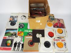 A collection of 7" vinyl records to include The Beatles, The Who, Wings, The Beach Boys and other.