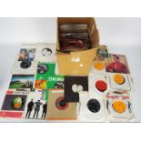 A collection of 7" vinyl records to include The Beatles, The Who, Wings, The Beach Boys and other.