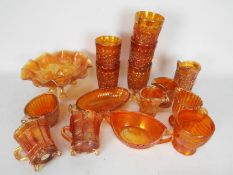 Carnival Glass - A selection of Carnival Glass to include tumblers, cups, jugs, handled bowls,