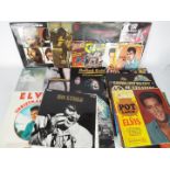 A collection of 7" and 12" vinyl records to include The Beatles, The Rolling Stones, David Bowie,