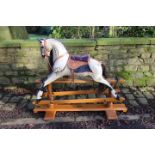 A Stevenson Brothers dapple grey rocking horse on trestle base,