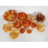 Carnival Glass - A collection of orange carnival glass to include shell dishes, jugs, flared dishes,