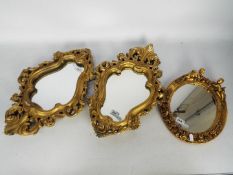 A pair of wall mirrors, approximately 48 cm x 33 cm and one other.