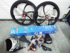 A boxed Bikemate Bike Work Stand, two Yuemei wheels with tyres and other cycling accessories.