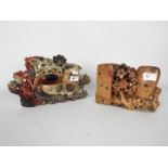 Two Asian carved soapstone double brush pots, the larger decorated with flowers, leaves and a bird,