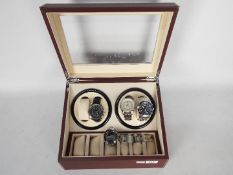 A Watch Winder / display case containing four fashion watches,