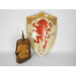A reproduction knight's helm and shield with rampant lion.