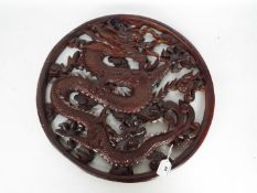 A carved wood 'Dragon' roundel, approximately 49 cm (h).