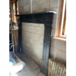 A Victorian cast iron fire surround measuring approximately 164 cm x 188 cm (130 cm between