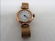 A lady's yellow metal cased wristwatch, case back interior stamped 9c,