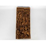 A South Asian wooden wall plaque, profusely carved in high relief, approximately 55 cm x 24 cm x 4.