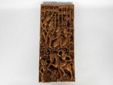 A South Asian wooden wall plaque, profusely carved in high relief, approximately 55 cm x 24 cm x 4.