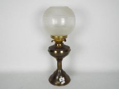 A vintage oil lamp with a height of 56 cm,