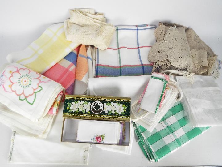 A box containing a quantity of vintage linen and similar.