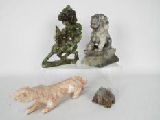 Stone carvings to include Buddhist Lion, Qilin and similar, largest approximately 21 cm (h).