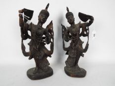 A pair of Asian carved wood figurines depicting ladies holding fans, approximately 36 cm (h).