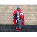 Life size model of a medieval knight's armour, fixed to wooden plinth,