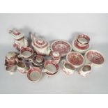 A collection of pink transfer printed dinner and tea wares, predominantly Spode Pink Tower pattern.