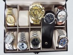A watch display case containing eight fashion watches,