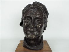 A contemporary bronze bust depicting an elderly lady, signed, approximately 27 cm (h),