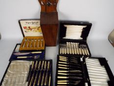 A quantity of cased and boxed flatware and a vintage wooden candle or salt box.