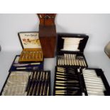 A quantity of cased and boxed flatware and a vintage wooden candle or salt box.