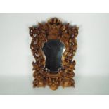 Wall mirror with intricately carved frame depicting dragons, flowers and similar,