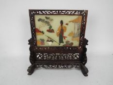 A carved wood table screen with faux jade panel, approximately 25 cm (h).