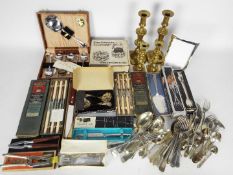 Lot to include stainless and plated flatware, part cased / boxed, brass candlesticks and other.