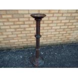 A mahogany torchere or jardiniere stand with helical turned column, approximately 96 cm (h).