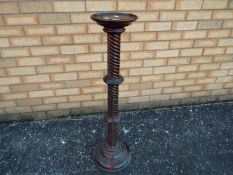 A mahogany torchere or jardiniere stand with helical turned column, approximately 96 cm (h).