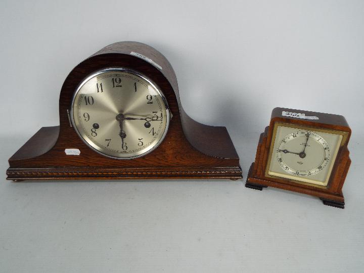 A mantel clock with key and pendulum and a small Art Deco Elliot clock.