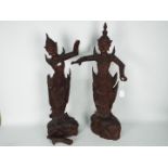 A large pair of South East Asian carved wood figures of female dancers,