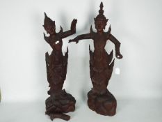 A large pair of South East Asian carved wood figures of female dancers,