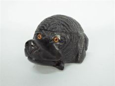 A black forest carved wood inkwell in the form of a dog's head with glass eyes and blue ceramic