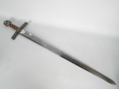 A decorative reproduction sword by Ancient Warrior, approximately 103 cm (l).