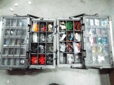 Two accessory organiser boxes, one containing automotive fuses,