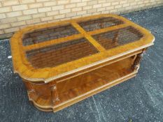 A coffee table with four glass panels inset to the top, approximately 44 cm x 127 cm x 76 cm.