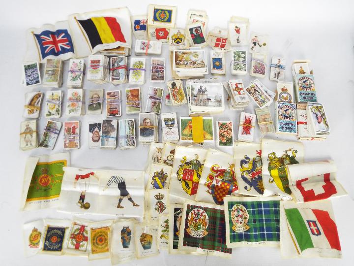 A collection of cigarette cards with a good quantity of silks including Heraldic, Regimental,