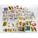 A collection of cigarette cards with a good quantity of silks including Heraldic, Regimental,