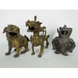 Three Asian cast metal figurines of creatures to include Buddhist lion and similar,