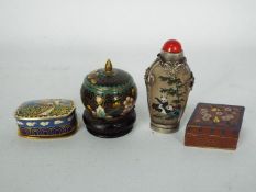 A reverse painted snuff bottle with white metal mounts,