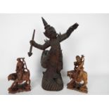 Three Asian carved wood figures, largest approximately 43 cm (h).