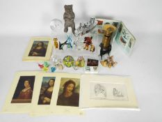 A mixed lot to include vintage money banks, paper weights, glass animals, Da Vinci prints,