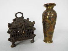 A cast metal cricket cage, 10 cm (h) and a small Cairoware vase.