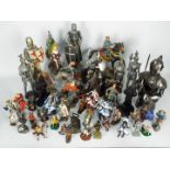 A large collection of figurines of knights, warriors, military figures, sizes vary.