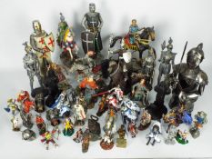 A large collection of figurines of knights, warriors, military figures, sizes vary.